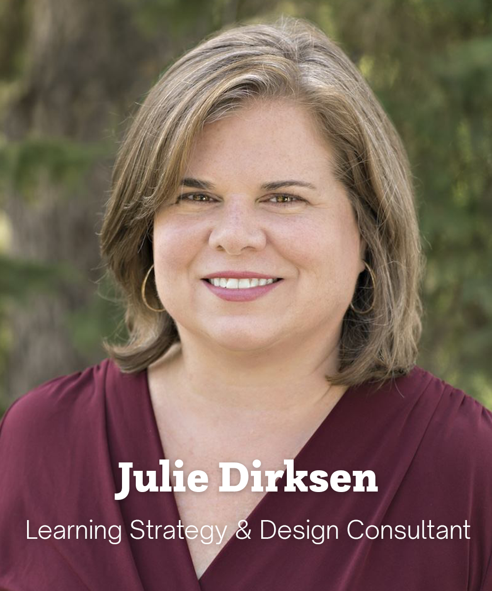 Julie has light skin and straight blonde hair at shoulder length. She is standing outside and smiling.